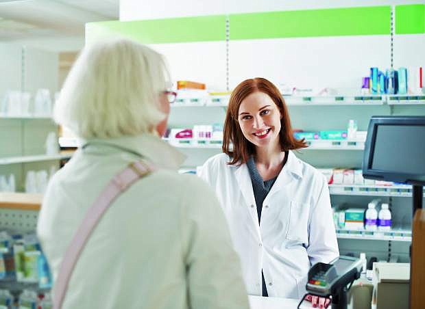 A pharmacist talks with a customer about keeping a healthy lifesuyle.