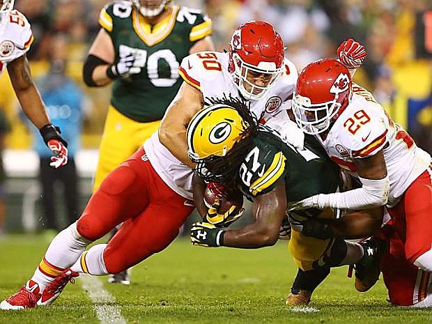Fallon&#039;s Josh Mauga (90) and teammate Eric Berry tackle Green Bay&#039;s Eddie Lacy (27) during Monday night&#039;s NFL game.