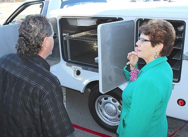 Driver Buster Pierce, left, explains to Dona Eveat the capabilities of the new truck that delivers meals to senior citizens.