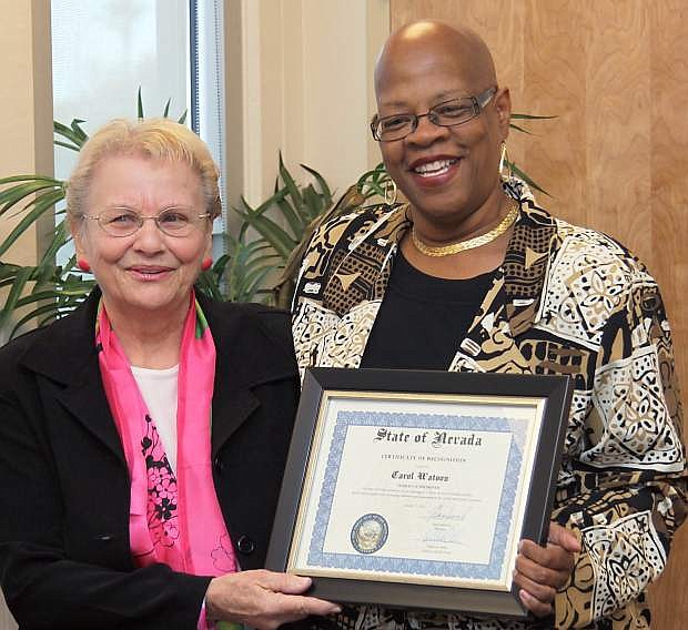 Deputy Director Willette Gerald presents the October Veterans of the Month award to Carol Watson.