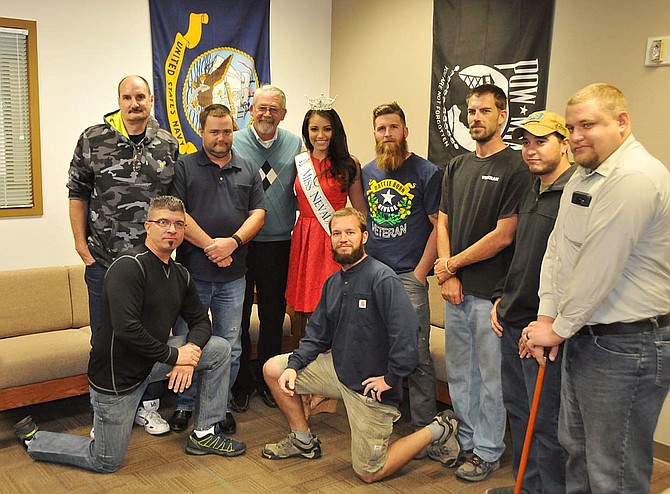 Western Nevada College student veterans, along with Veterans Resource Center Coordinator Kevin Burns, fourth from left, and Aaron Endel, far right, an administrative assistant in financial assistance, pose with Miss Nevada 2016 Bailey Gumm on Tuesday in Carson City.