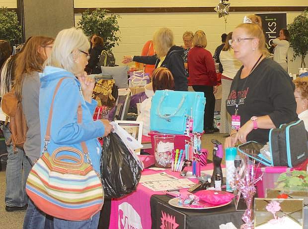Shoppers look at the various items offered at Wednesday&#039;s annual Mother&#039;s Day Extravanza.