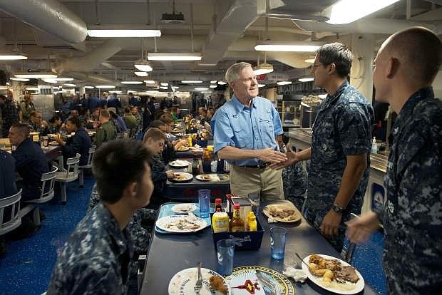 Secretary of the Navy Ray Mabus meets with sailors on the mess decks of the aircraft carrier USS George H.W. Bush.