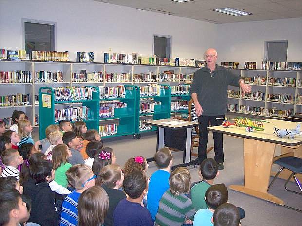Bill Slentz, a Fallon author of a children&#039;s books, talks about his story and shows model airplanes of those depicted in his book to Numa Elementary School students.