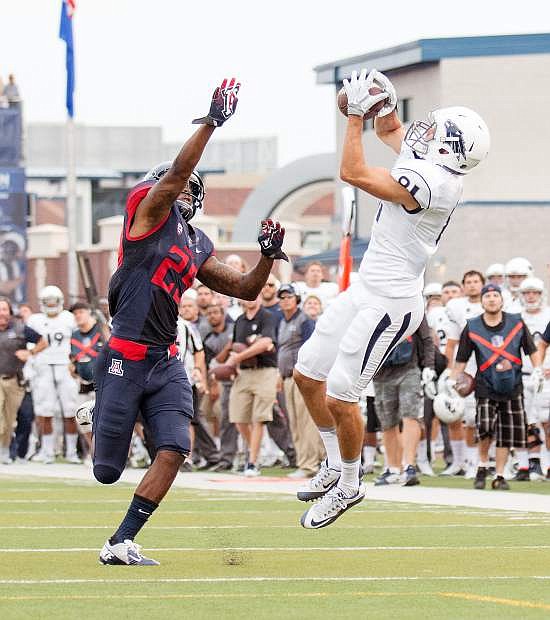 Nevada freshman Victor Gonzalez tries for a second-quarter reception Saturday against Arizona cornerback Jarvis McCall in the Wolf Pack&#039;s loss to the Wildcats last Saturday, Sept. 12, at Mackay Stadium.