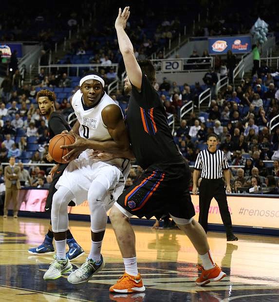 Nevada&#039;s Cameron Oliver posts up against Boise State&#039;s Nick Duncan.
