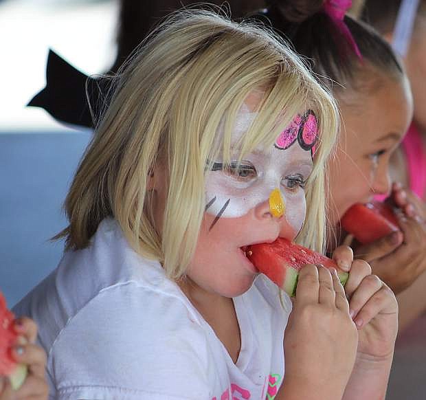 Watermelon eating is a favorite at the family day activities at the fairgrounds on the Fourth of July.