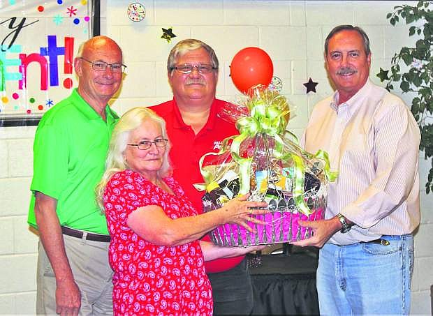 Councilman Bob Erickson, left, and Mayor Ken Tedford, right, present a gift to both Laura and Vern Ulrich upon his retirement.