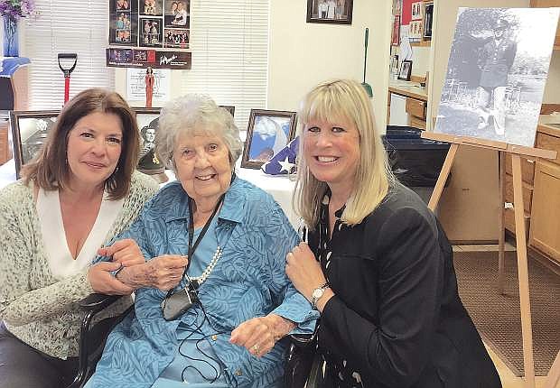 Tracy Soliday, left, of Congressman Mark Amodei&#039;s office, and Glenna Smith, right, of Sen. Dean Heller&#039;s office, pose with Margaret Quinley after mass was held on Saturday for Cecil Quinley, a 100-year-old World War II veteran who passed away on March 14.