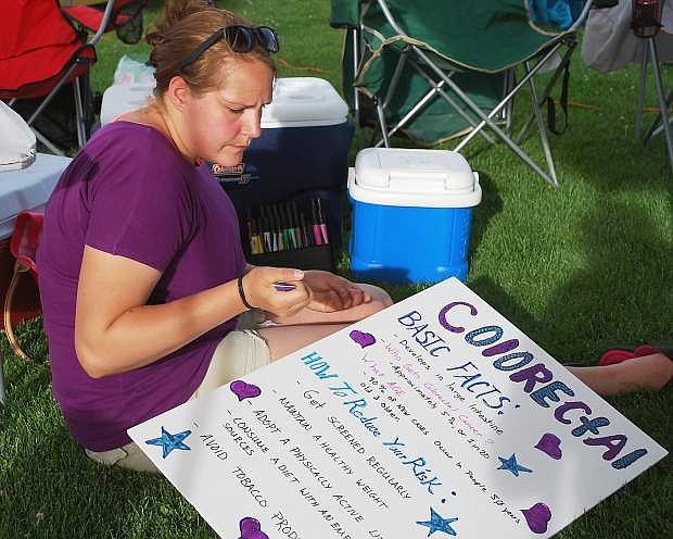 Nichole Petri of the Association of Aviation Ordnancemen at Naval Air Station Fallon puts the finishing touches on a Relay for Life cancer sign. Additional photos on pages 16-17.