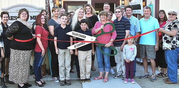 Those who attened a ribbon cutting for Rescue Me include, from left Natalie Parrish, Chamber of Commerce executive director; Cindy McGarrah, Chamber secretary; JenniLei Biser; Christy Lattin, Chamber ambassado; DeLea Johnson; Connor Oceguera; Corbin Rollano; Jody Jarvis, Rescue Me owner; Schyler Jarvis; Kenyon Jarvis; Layne Wilhelm; Lisa Gonzales, Chamber ambassador; and Kim Klenakis, Chamber board member.