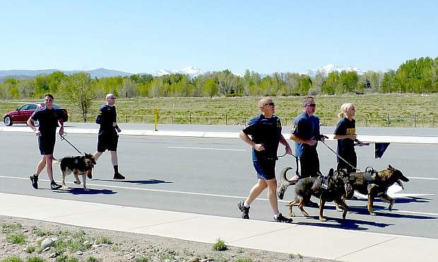 Douglas K9 runners pass the Gardnerville Walmart on Wednesday morning.