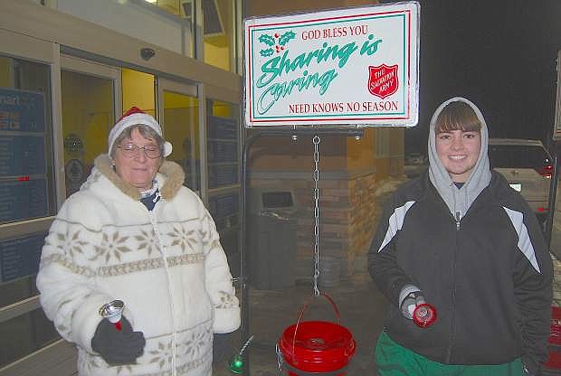 Francie Lee, left, and Samantha Lamb volunteer as bell ringers for the Salvation Army&#039;s Red Kettle program.