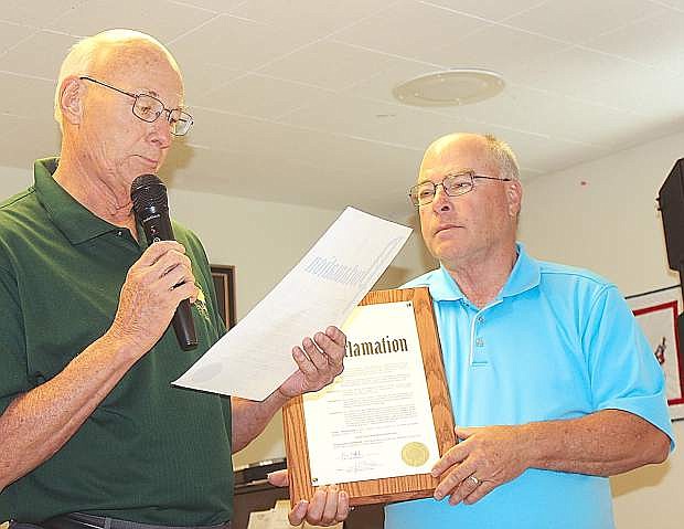 Fallon Councilman Bob Erickso, leads,n reads a proclamation Friday recognizing National Senior Citizen Day. Holding the proclamation is Churchill County Commissioner Bus Scharmann.