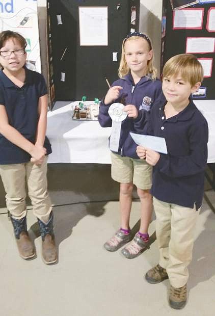 Mattie Zulz, Natalie Jaques and Levi Johnson won third place for their entry on chores, then and now.
