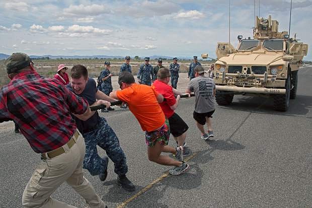 The Security team pulls a Mine-Resistant Ambush Protected (MRAP) vehicle during the Sexual Assualt Awareness and Prevention Month closing ceremonies aboard Naval Air Station Fallon.