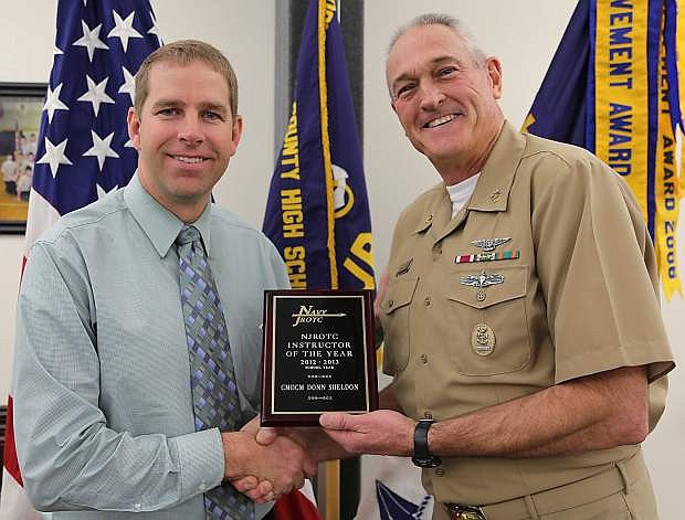 CCHS principal Kevin Lords, left, presents Master Chief Donn Sheldon with the Navy Junior ROTC Area 13 Teacher of the Year Award.