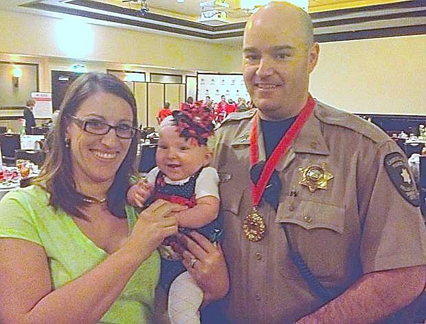 Sgt. Ron Bell poses with his wife, Aimee and daughter, Payslee.