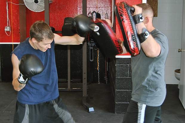 Dylan Baker, left, and Sean Hill are using the new equipmentat the Sparta Athletic Training Center.