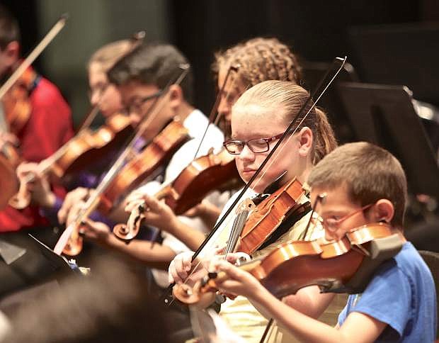 Violinists perform Thursday evening at the Carson City Symphony&#039;s Strings in the Schools Spring Fling Concert at the community center.