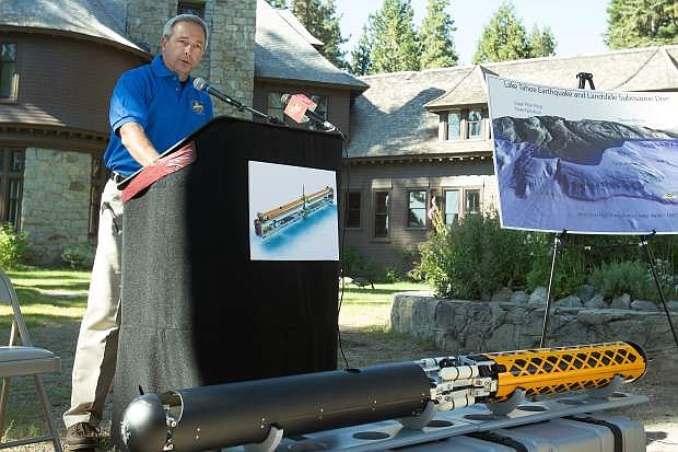 March Nechodom, director of the California Department of Conservation speaks to reporters at Sugar Pine State Park Thursday. In front of Nechodom is a quarter-scale model of the submarine.