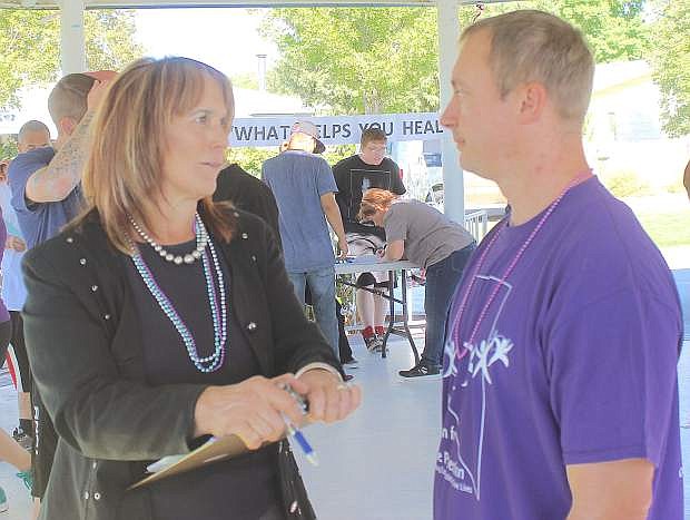 Andrea Zeller, left, executive director of the Churchill Community Coalition, thanks Neale McPherson for his contribution of more than $1,000 for suicide awareness and prevention.