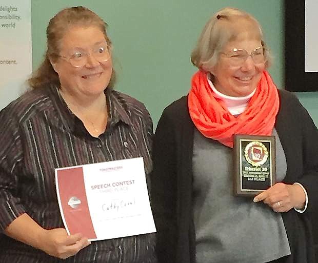 Cathy Coval, left, holds her Certificate of Participation and Suzann Gilliland Peterson shows her second-place plaque.