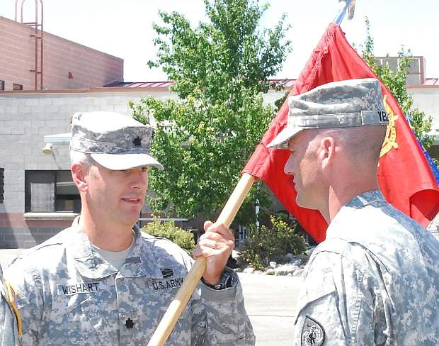 Capt. Christopher Yell of  Elko receives the guidon from Lt. Col. Eric Wishart, left, commander of the 757th CBT Sustainment Support Battalion.. Yell became the new commander of the Nevada Army National Guard&#039;s  593rd Transportation Company on Saturday.