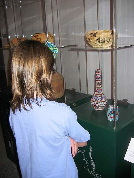 A child looks at some of the dipalys at the Nevada Historical Society in Reno.