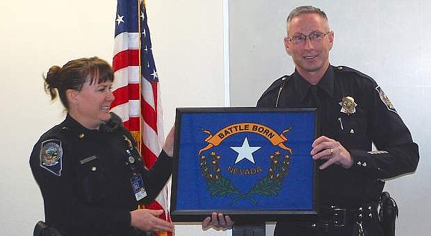 Maj. Susan Aller-Schilling presents a Nevada flag to Trooper Chuck Allen. The flag flew over the Nevada Highway Patrol&#039;s  Northern Command&#039; headquarters on Nov. 26, 2014.