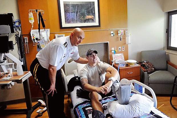 Retired Army Chief of Staff Gen. Raymond T. Odierno shakes hands with a wounded warrior during a 2011  visit to the Walter Reed National Military Medical Center in Bethesda, Md.,