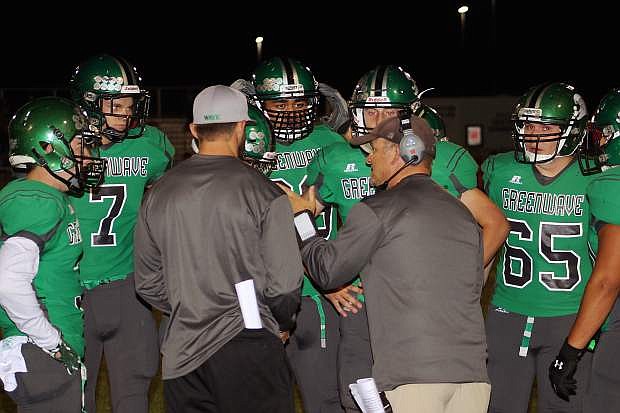 The Greenwave coaching staff assembles the team into a huddle at Fallon&#039;s last home game. Fallon entertains Elko tonight at 7 p.m. for Homecoming.