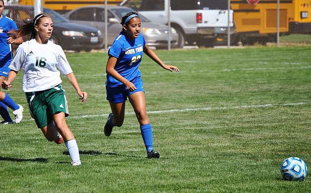Wave senior Kayla Biggs,left, competing with Vikings senior Stacy Vasquez for control. Mike Sciandra / LVN
