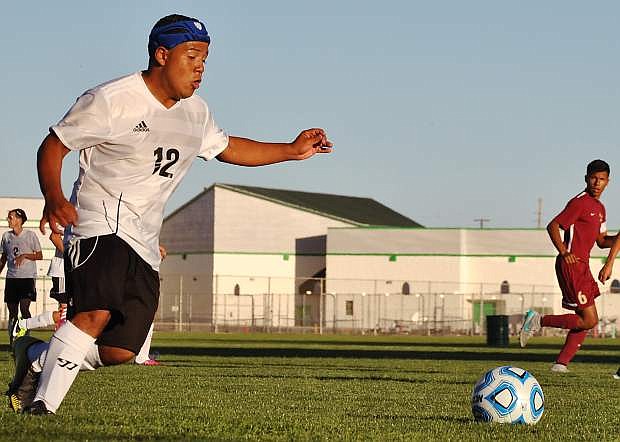 Wave junior Angel Cornejo (left) charges away from Sparks junior captain Alex Medina.