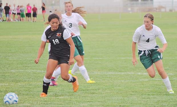 Wave sophomore Caitlyn Welch, right,  races to regain possession against the Vaqueros offense.