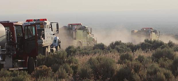 Bureau of Land Mangement engines and their fire crews begin their journey early Thursday morning to report to the Incident Command that is handling the Little Den Fire east of Fallon.