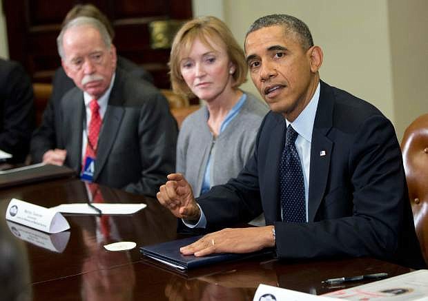 President Barack Obama makes a statement in the Roosevelt Room of the White House in Washington, Friday, Nov. 15, 2013, before the start of a meeting with representatives of health insurance companies. From left are, Senior Adviser, Health and Human Services Office of Health Reform Michael Hash, Marilyn Tavenner, head of the Centers for Medicare and Medicaid Services and the president. The president said he brought health insurance CEOs to the White House to brainstorm ways to make sure Americans know what their coverage options are under the law. (AP Photo/ Evan Vucci)
