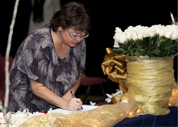 Christine Higley signs the book as a newly inducted member of the Alpha Upsilon Beta Chapter of Phi Theta Kappa Honor Society during the induction ceremony at Western Nevada College on Friday, April 8. Photo by Shannon Litz/Nevada Photo Source