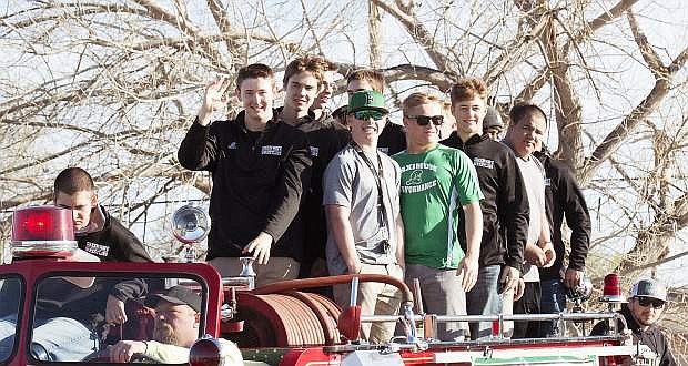 The Fallon wrestling team rides the city fire truck during an escort Monday afternoon.