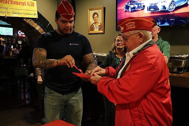 It&#039;s a tradition for the oldest veteran marine (Joe Gabiola) to take a bite and pass down a slice to the youngest marine (Martin Rodriguez).