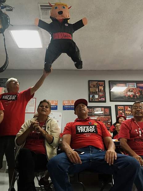 Members of the Culinary Workers Union Local 226, cheer during a rally under a Donald Trump pinata in Las Vegas Monday, Nov. 7, 2016. Voters in swing state Nevada will play an outsized role on Tuesday when they decide whether Hillary Clinton or Donald Trump should get their six coveted electoral votes. The state also has seen a high number of Latinos vote early where Democrat Catherine Cortez Masto is trying to become the nation&#039;s first Latina senator. (AP Photo/Russell Contreras)