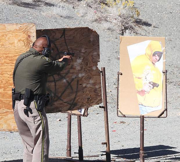 Deputy Izzy Loyola shoots at an &quot;armed suspect&quot; at the gun range for the Carson City Sheriff&#039;s Office In Service Training and firearms qualifications.