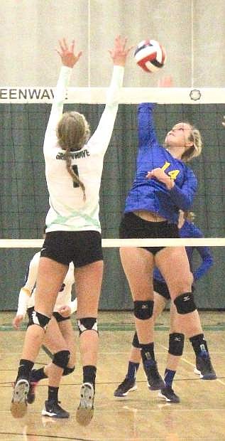 Hannah Hillyer (14) of Lowry tries to power the ball against Fallon&#039;s Whitney Skabelund.