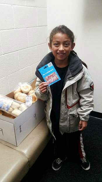 Angel, a third grade student at Mark Twain Elementary School, opens his NHS food basket.