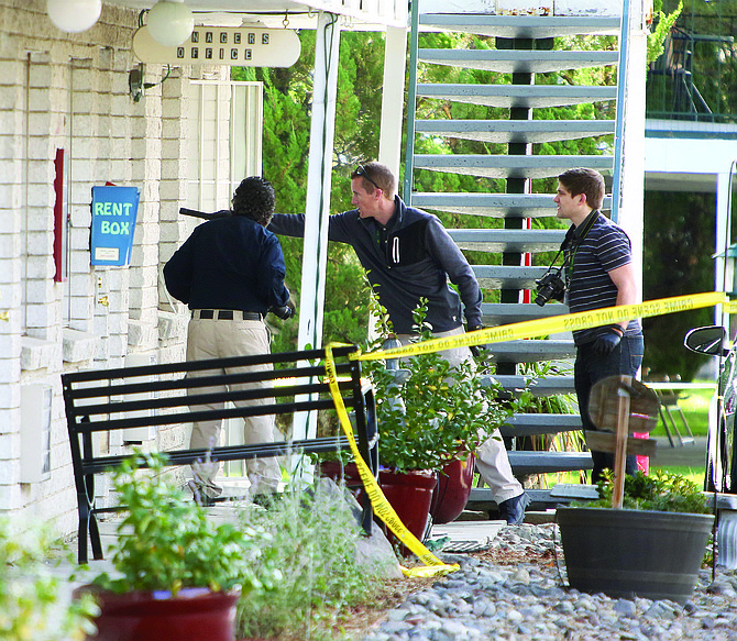 Crime scene investigators arrive at the Senator apartments on Tuesday morning to investigate the site of a fatal shooting.