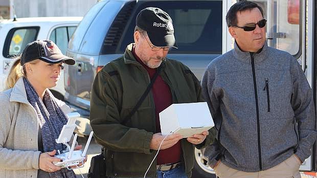 Drone operator Lacey Szekely maneuvers the Unmanned Aerial Vehicle, while Steve Endacott views its progress. To their right is Fallon Police Capt. Ron Wenger..