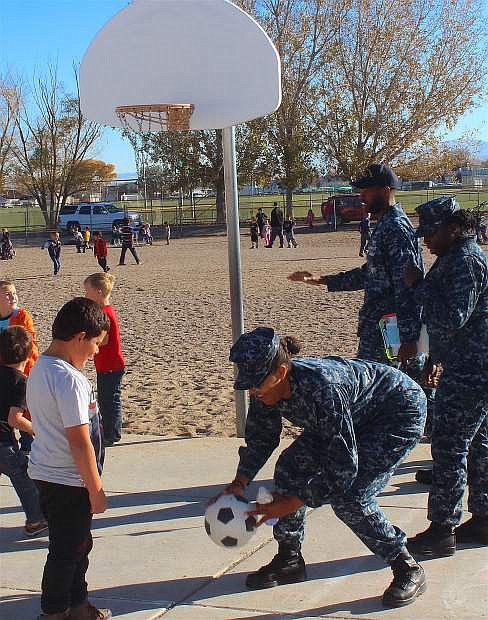 Navy service members entertain Lahontan Elementary School students during the breakfast the school hosted for service members, retirees and their families in honor of Veterans Day.