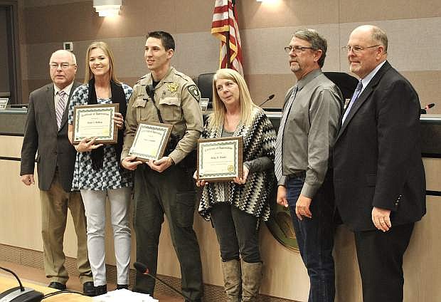 Linda Rothery, Trevin Goodrick and Holly Meader (middle three) join commissioners Bus Schermann (far left), Carl Erquiaga and Pete Olsen after being presented service awards for their years working for the county.