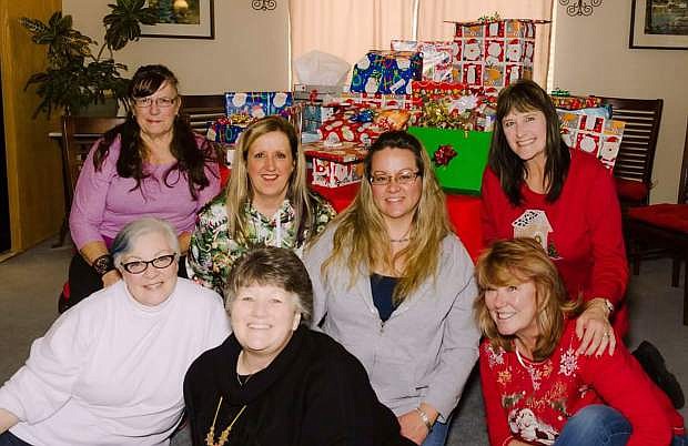 The Dicey Dames, a Dayton Bunko group, adopts a family every year for Christmas. Shown are Mary Culwell, Debbie Garretson, Brandi Gramolini, Pam Walsh, Melody Hoover, Kelly Knapp and myself Connie Corley along with presents for four local children.