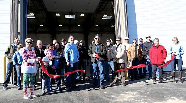 Facilities Manager Ralph Negron accompanied by other NVEnergy employees and local dignitaries cuts the ribbon of the new truck barn on E. Long Street in Carson City Saturday morning.